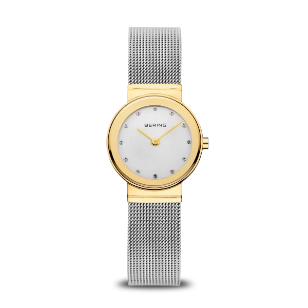 The Bering Watch - Classic Collection Womens Gold (10126-001) features a gold-tone round case, white dial with crystal markers, and a silver mesh band—showcasing Bering’s Danish-inspired design against a plain white background.