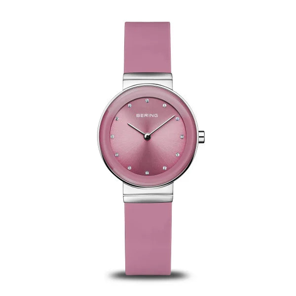 The Bering Watch - 10129-909 from the Classic Collection features a pink strap and dial with silver hour markers, the Bering logo on the face, and a stainless steel case for a sleek, modern look.