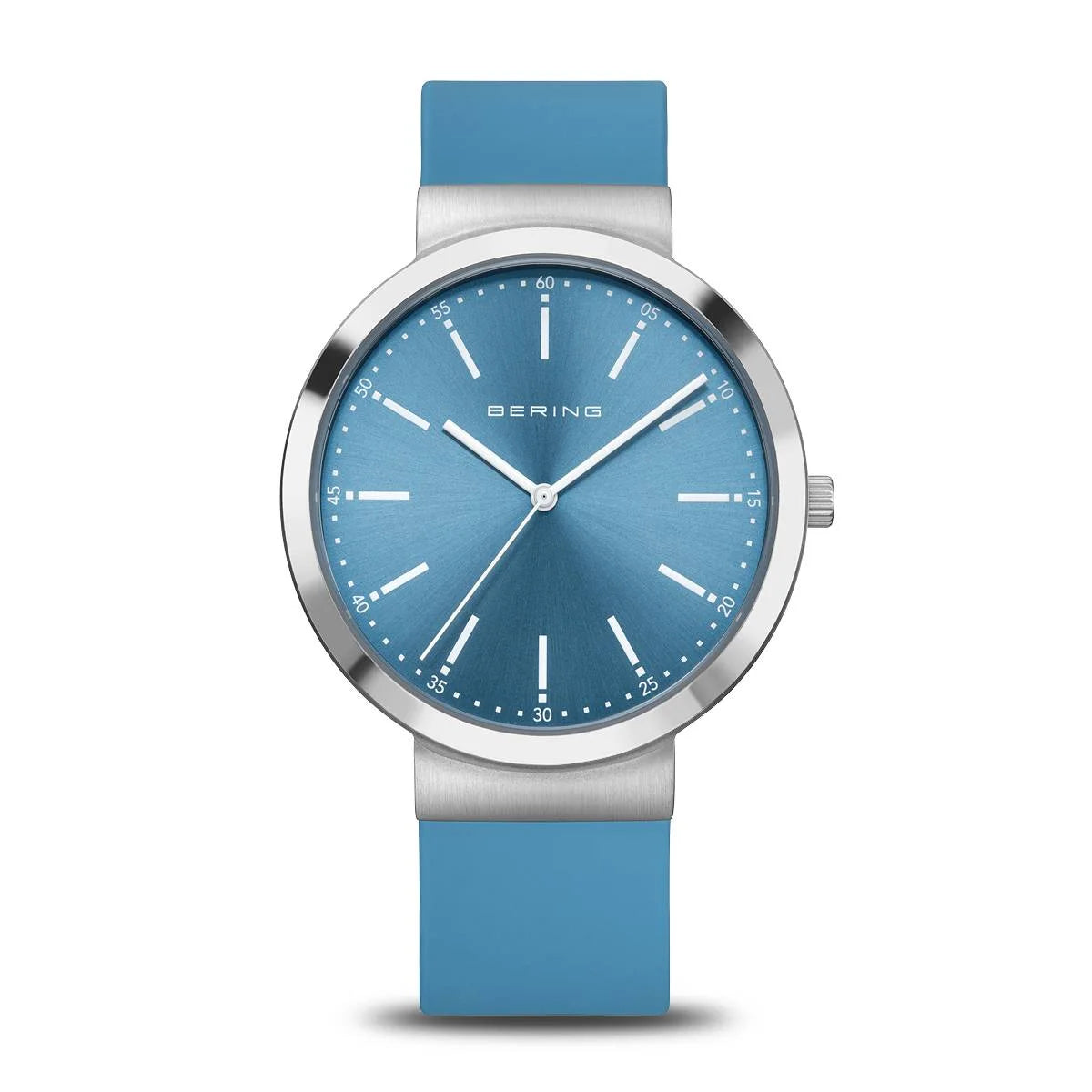 The Bering Watch - Classic Collection - 10141-398 is a minimalist women’s watch with a blue face and strap, silver hour markers and hands, sapphire crystal, silver bezel, and the BERING name at the top of the dial.