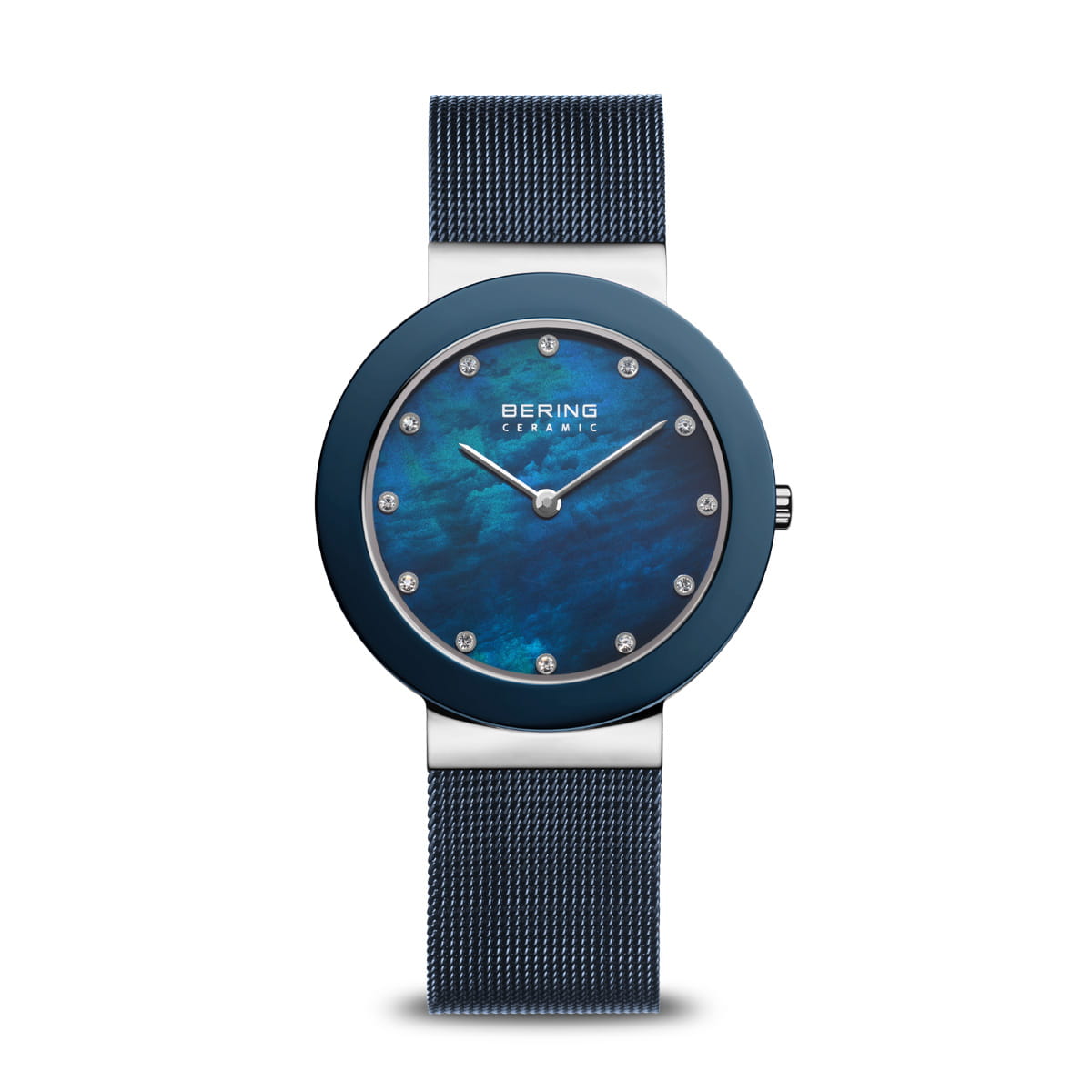 The Bering Watch - Ceramic - 11435-387 is a stylish women’s watch with a blue mesh band, sapphire crystal, round blue ceramic bezel, textured blue face with silver markers and hands, and “BERING” displayed on the dial.