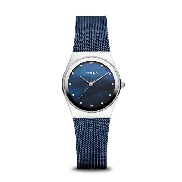 The Bering Watch - Classic Collection Womens Blue Mother of Pearl (12927-307) features a blue mesh band, round silver case, blue face with minimalist dot markers and silver hands. BERING branding is visible on the dial.
