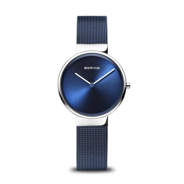 The Bering Watch - Womens Classic Collection 14531-307 features a blue sunburst dial, silver hands, no hour markers, and a blue Milanese strapβa sleek, minimalist design ideal for any occasion.