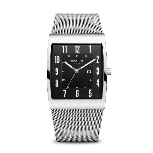 The Bering Watch Mens Slim Solar Collection 16433-002 features a rectangular black dial with silver markers, a date window, and a silver mesh band. This eco-friendly watch offers a minimalist, modern design by Bering.