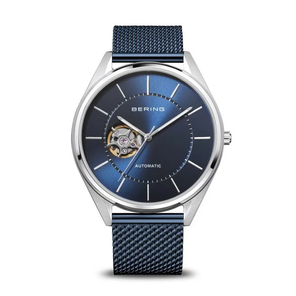 The Bering Watch - Blue Dial Automatic (16743-307) features a blue mesh strap, silver case, silver hour markers and hands, plus an open-heart blue dial that showcases its intricate automatic movement.