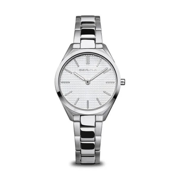 The Bering Watch - 17231-700 is a womens timepiece with Danish-inspired design, featuring a silver metal band and a white textured dial with minimalist silver markers and hands for an elegant look.