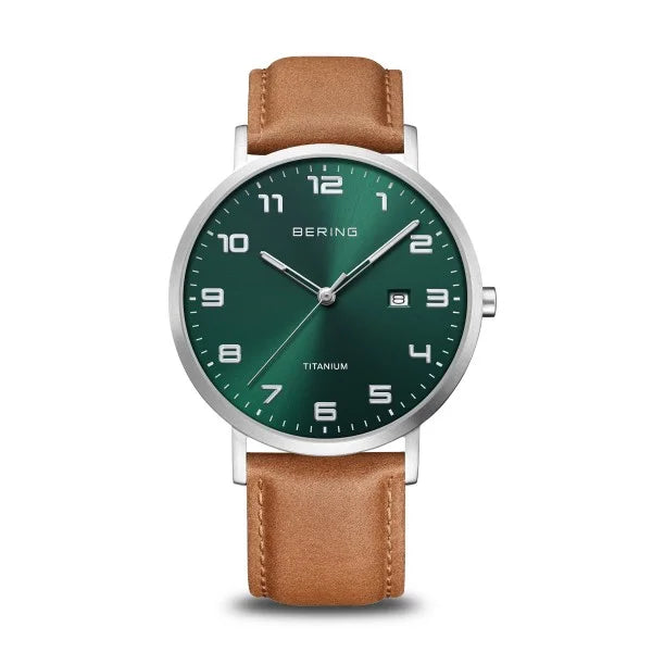 The Bering Watch - Ultra-Light Titanium Collection 18640-568 features a brown leather strap, green dial with white Arabic numerals, silver hands, date window at 3 o’clock, and a sleek silver case.