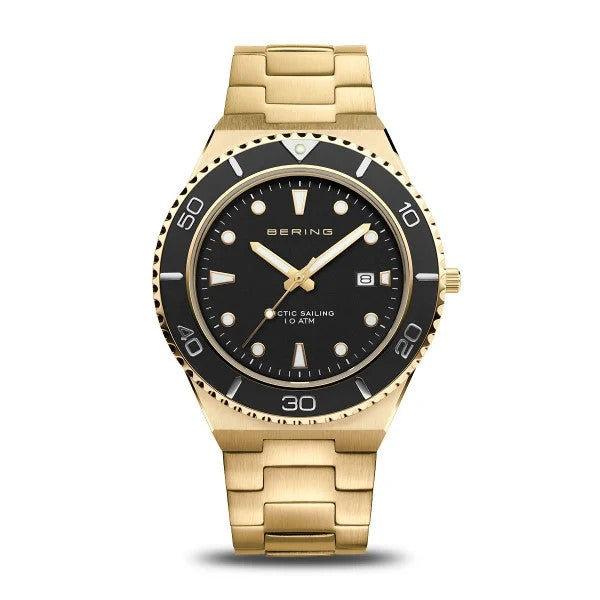 The Bering Watch - Arctic Sailing Collection Mens Gold (18940-732) features a black bezel and dial, luminous markers, date window at 3 o’clock, BERING ARCTIC SAILING 10 ATM on the face, and a classic metal link band.