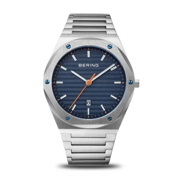 The Bering Watch - Classic Collection Mens Blue (19742-707) by Bering features a blue textured dial, orange hour markers, slim hands, date window at 6 o’clock, and a stainless steel link bracelet—perfect for any occasion.