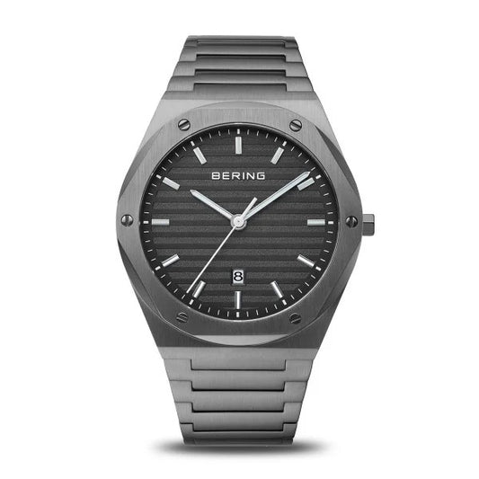 The Bering Watch - Classic Collection Mens Grey (19742-777) features a brushed metal bracelet, black dial, silver markers and hands, date window at 6 o’clock, and a sleek minimalist design.