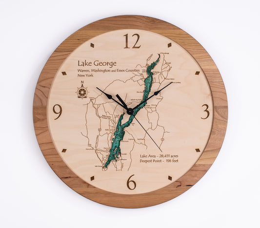 The Lake Art Lake Clock - Lake George is a round wooden clock featuring a carved, painted map of Lake George, NY with county labels and lake stats—perfect as Adirondacks decor or a unique custom gift.