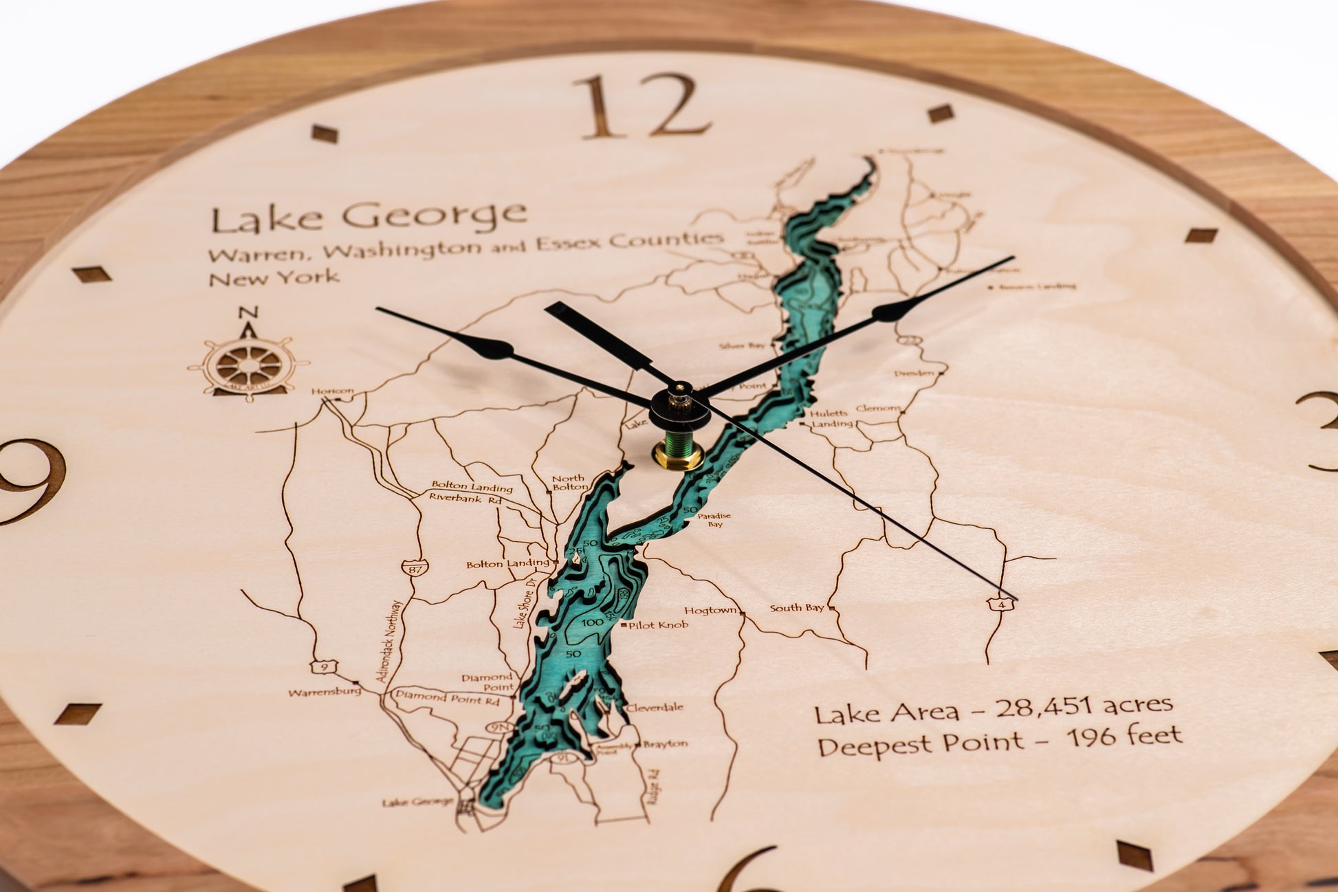 The Lake Art Lake Clock - Lake George is a custom wooden clock featuring a detailed, blue-green map of New York’s Lake George with labeled towns, depths, and area—ideal for Adirondacks decor or as a unique lake gift.
