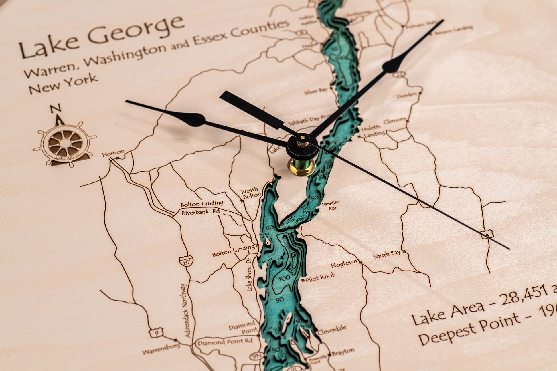 The Lake Art Lake Clock - Lake George is a custom wooden clock featuring a carved map of Lake George, NY and labeled towns—ideal Adirondacks decor or a thoughtful lake house gift.