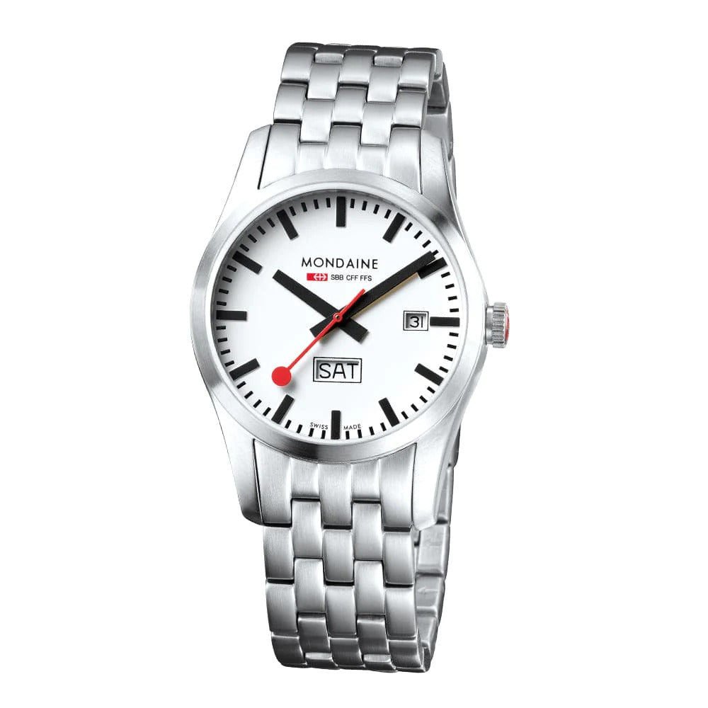 The Mondaine Watch - Retro - A667.30340.16SBM features a white dial, black markers, red seconds hand, date at 3, and day above 6. Its vintage design pairs with a stainless steel bracelet band. Swiss Made quality from Mondaine.