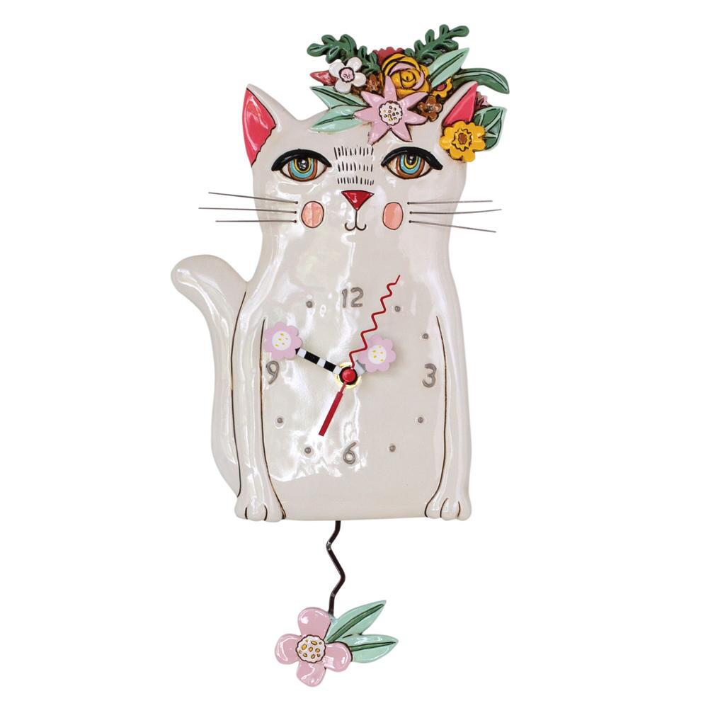 The Enesco Allen Designs Clock - Pretty Kitty (P1993) is a whimsical wall clock with a white cat, floral crown, rosy cheeks, expressive eyes, flower-shaped pendulum, and pink flower-detailed hands.