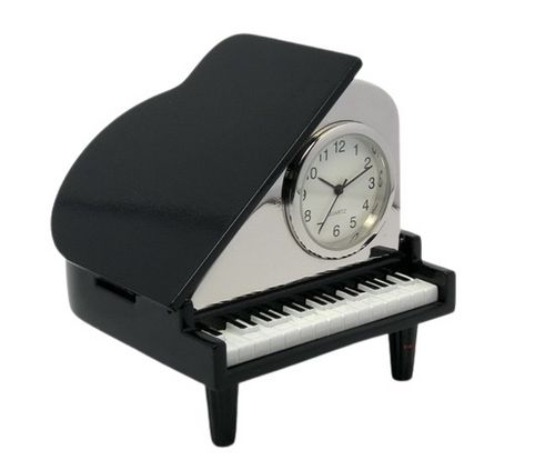 The Sanis Enterprises Sanis Mini Clock – Mini Grand Piano Black (model C3018BK) is crafted to resemble a black grand piano, with a miniature clock face set into the raised lid and detailed white piano keys beneath.