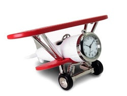 The Sanis Enterprises Sanis Mini Clock - Red & White Plane (C3569WHRD) features a creative design with the clock face set in the plane's nose.