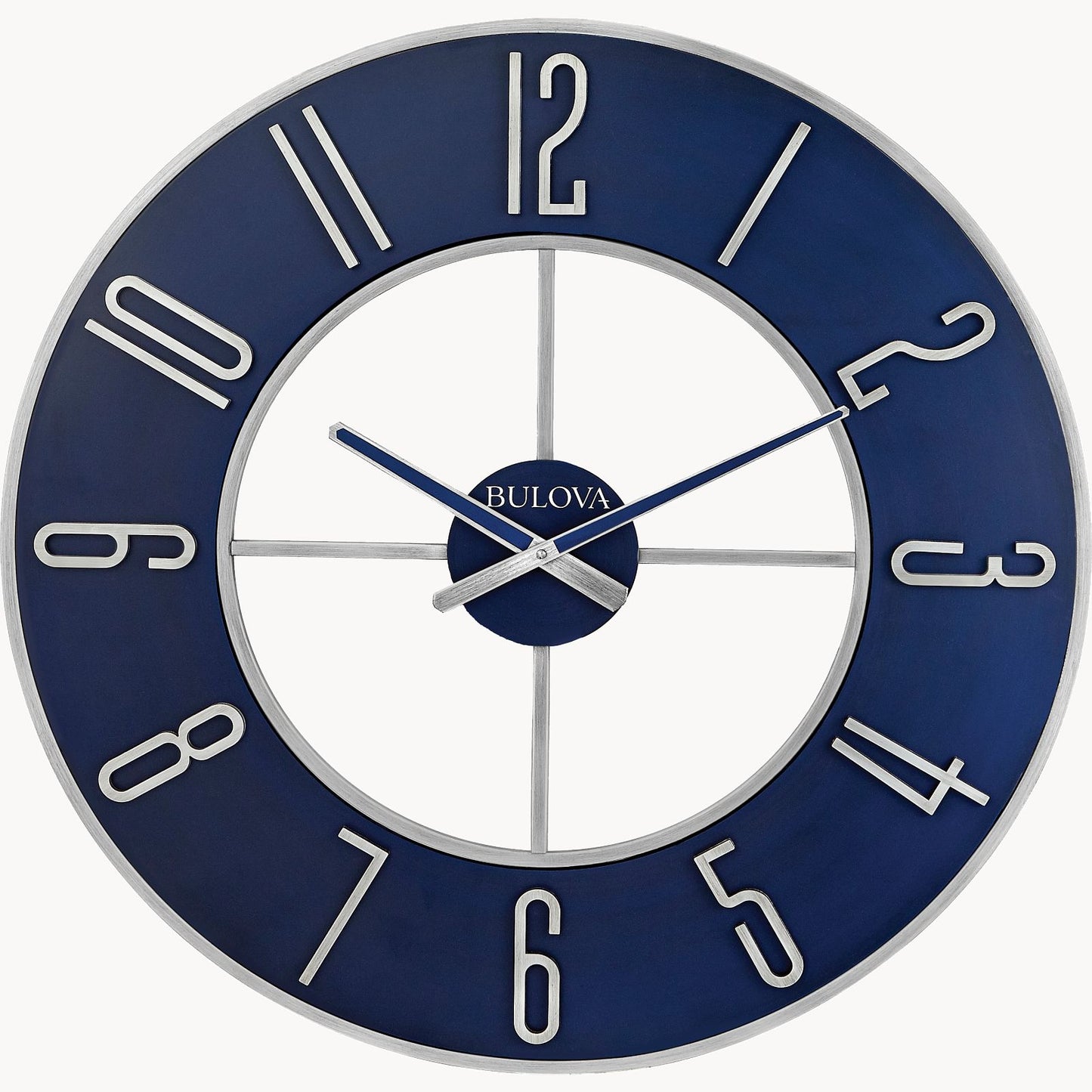 The Bulova Clock - Blue Steel (C4809) features a steel blue dial, silver frame, large silver numbers, and open-center design. Silver hands set to 10:10 and the white Bulova logo at center add a sleek modern touch to any room.