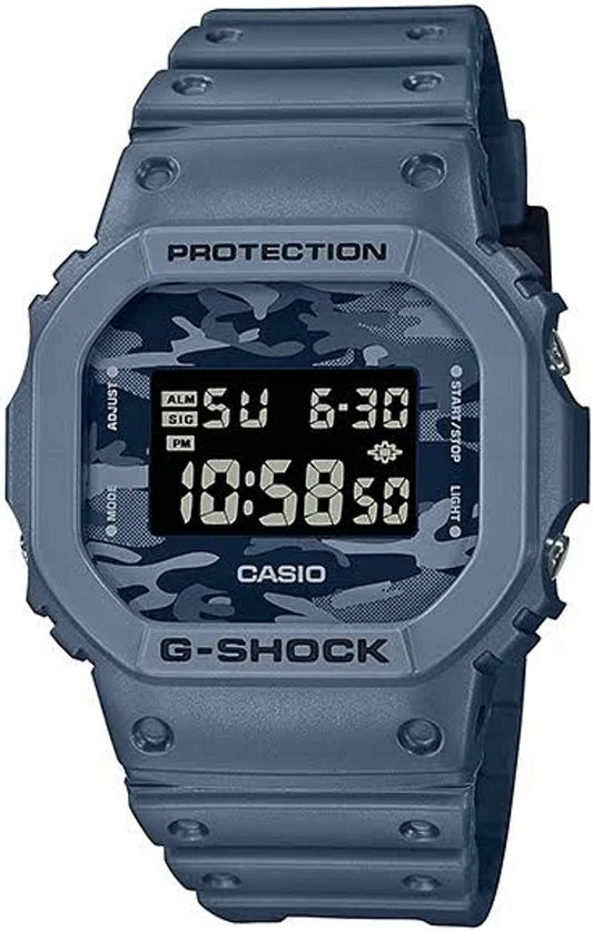 The Casio G-Shock Watch DW5600CA-2 by VLC Distribution Co. is a shock-resistant gray watch with a camouflage face, labeled buttons, rugged design, and digital display showing 10:58:40 and Sunday 6-30.