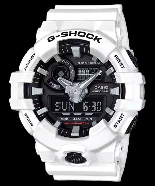 The Casio G-Shock Watch - Analog/Digital - GA700-7A from VLC Distribution Co. is a white watch with labeled side buttons, a black face, and displays the time, date, and various functions.
