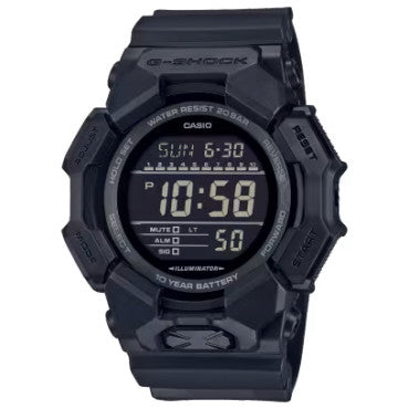 The Casio G-Shock Watch - World Time - GD010-1A1 by VLC Distribution Co. is a black, rugged digital watch showing 10:58, Sunday 6-30, with alarm, mute, battery life indicators, and a reliable 10-year battery.