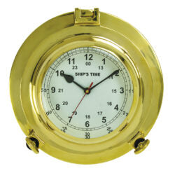 The Moby Dick Ltd - 9" Porthole Clock (MC-234) features a white face with black numbers and hands set at 10:09:35, labeled SHIPS TIME, and has frame latches resembling a ship’s porthole.