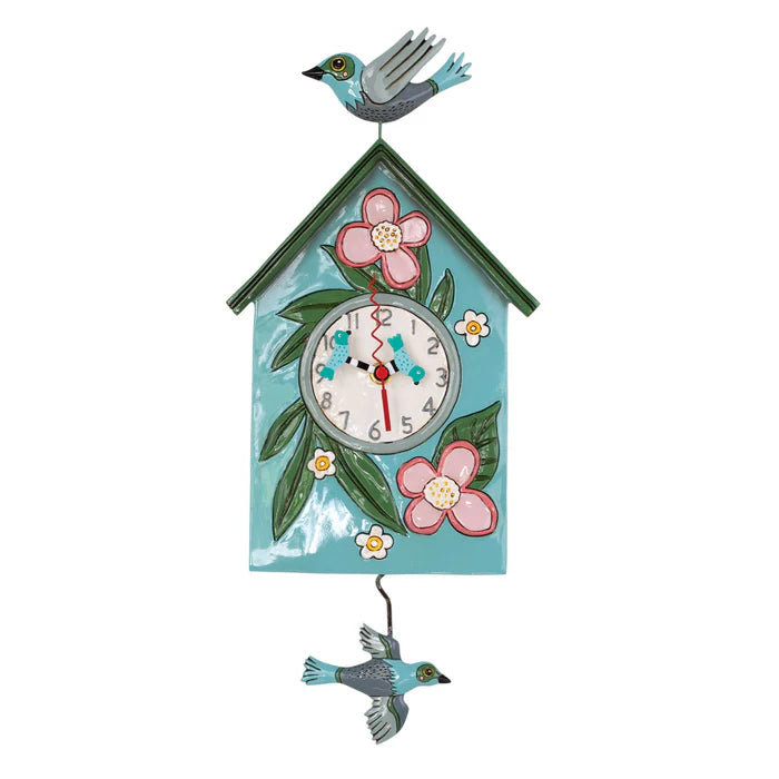Brighten your home with the Enesco Allen Designs Blessed Nest Clock (P1994)—a hand-painted birdhouse clock adorned with pink flowers, green leaves, a cheerful bird topper, and a playful bird pendulum.