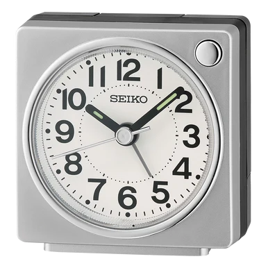 The Seiko Clocks QHE196SLH Bedside Alarm Clock shows 10:09:38, featuring black numerals, luminous hour and minute hands, a top right button, and a quiet sweep second hand.