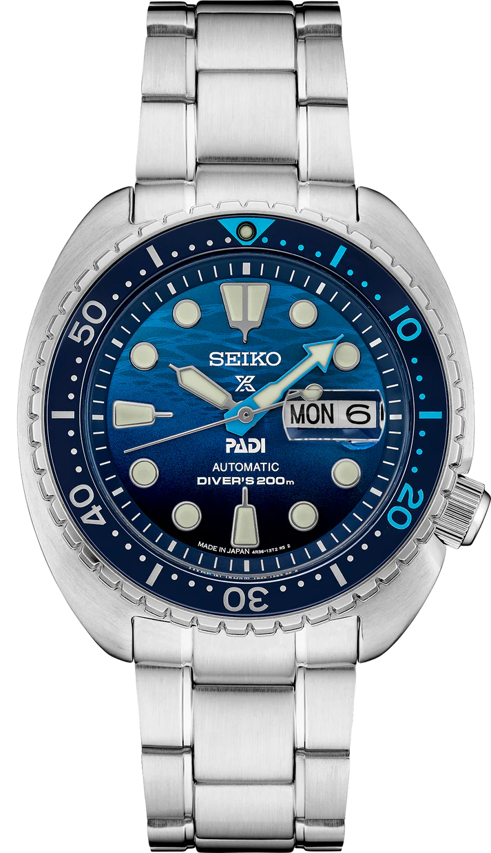 The Seiko Watch - Prospex PADI Special Edition - SRPK01 features a blue wave-pattern dial, silver indices, day-date window at 3 o’clock, stainless steel bracelet, and is water resistant up to 200m.