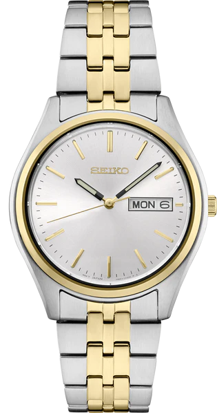 The Seiko Essentials SUR430 watch features a white sunray dial, gold hour markers and hands, a two-tone silver and gold stainless steel band, and a day-date display on the right.