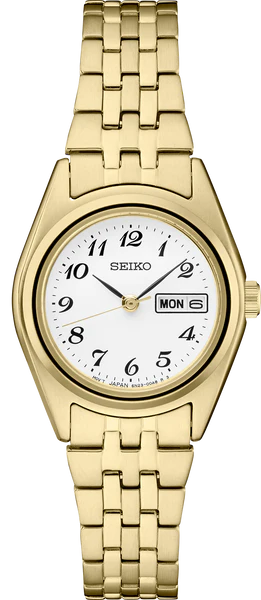 The Seiko Essentials SUR440 is a gold-tone stainless steel watch with a white dial, black Arabic numerals, gold hands, day-date display, and a classic linked band.