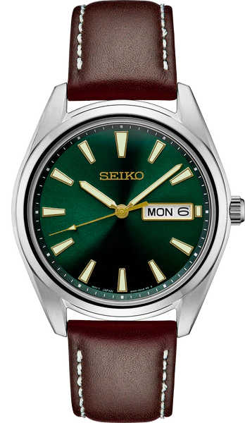 The Seiko Watch - Essentials - SUR449 features a striking green sunray dial, gold hands and hour markers, day-date display, and a brown leather strap with white stitching.