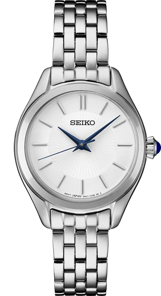 The Seiko Watch - Essentials - SUR537 features a stainless steel link band, white dial, silver markers, and two metallic hands. Its blue-accented crown enhances the minimalist design. No numbers or date window are present.