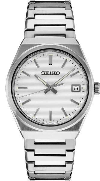 The Seiko Essentials SUR553 watch has a silver-tone stainless steel band, white textured dial, silver hour markers, date window at 3 o’clock, and sapphire crystal with the Seiko logo below 12 o’clock.