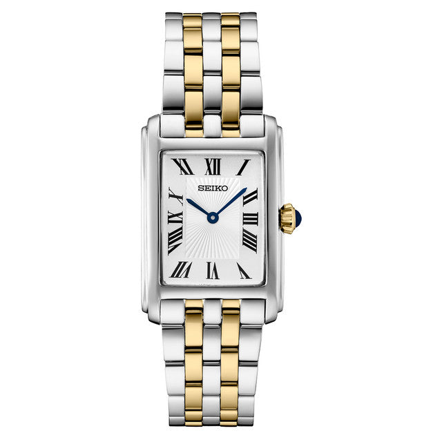 The Seiko Essentials SWR087 watch by Seiko features a rectangular case, two-tone stainless steel bracelet, white dial with black Roman numerals, blue hands, and a crown accented with a striking blue tip.
