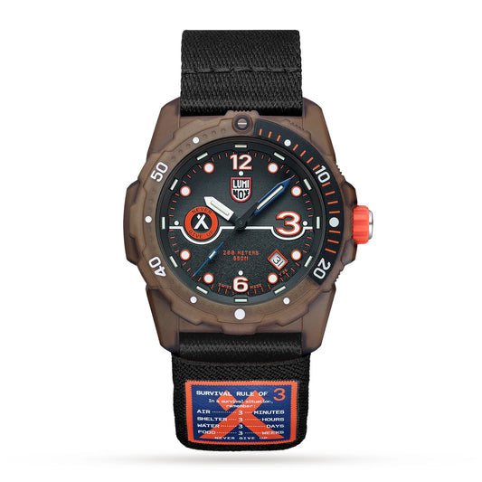 The Luminox Watch - Eco Tide Series - XB.3721.ECO features a black upcycled plastic strap with a survival rule patch, bold orange numerals at 12, 3, 6, and 9 on the dial, and a black bezel for a rugged look.
