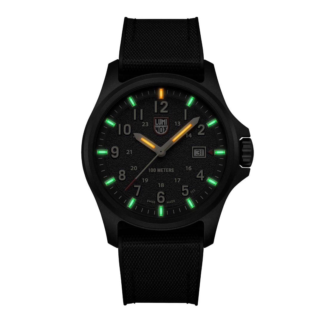 The Luminox Atacama Field 1970 (XL.1970) is a black CARBONOX watch with a black strap, glowing green markers, orange 12 o’clock marker, white numerals, sapphire crystal, date at 3 o’clock, and 100m water resistance.