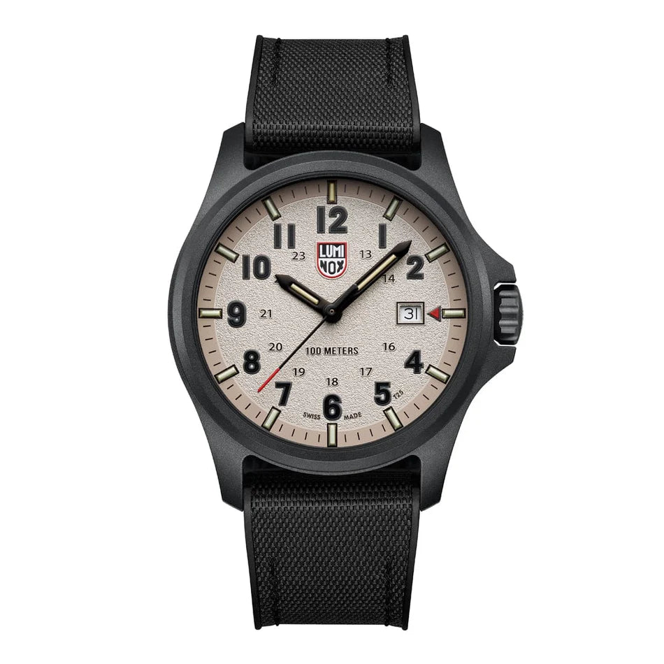 The Luminox Watch - Atacama Field - XL.1971.SET has a black CARBONOX case, beige face, black markers, date at 3 o’clock, a textured black band, and the Luminox logo under 12 o’clock.