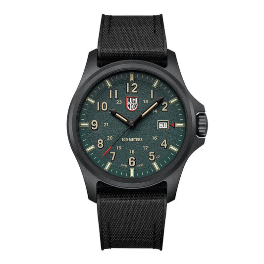 The Luminox Atacama Field Watch 1977 (XL.1977) features a black case, dark green dial with white/beige numerals, luminous hands, date window at 3 o’clock, Swiss Quartz movement, textured black strap, and is water-resistant to 100 meters.