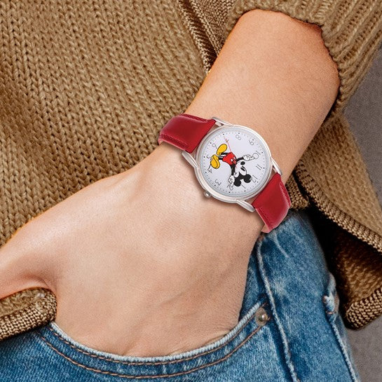A person in blue jeans and a brown sweater wears the Quality Gold Watch - Mickey Red Strap Adult (XWA5771), a playful unisex quartz watch from Quality Gold featuring Mickey Mouse for a charming touch to any outfit.
