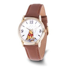 The Quality Gold QG Watches Disney Adult Winnie the Pooh (XWA6730) features a unisex gold-tone case, brown leather strap, and a charming Pooh image on the white dial with black numerals—perfect for any Disney fan.