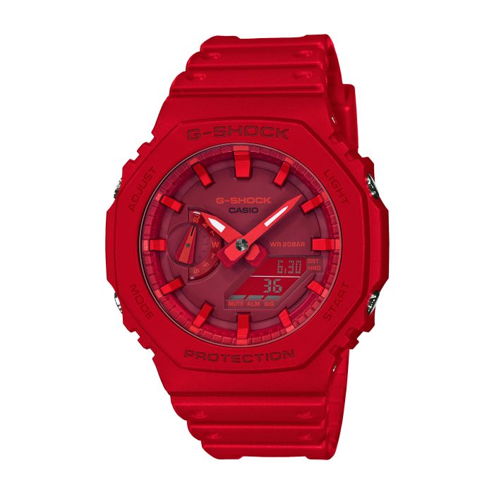 The Casio G-Shock Watch - Carbon Core - GA2100-4A by VLC Distribution Co. features a bold red design, analog/digital displays, labeled buttons, a textured band, and a shock-resistant carbon core guard for extra durability.