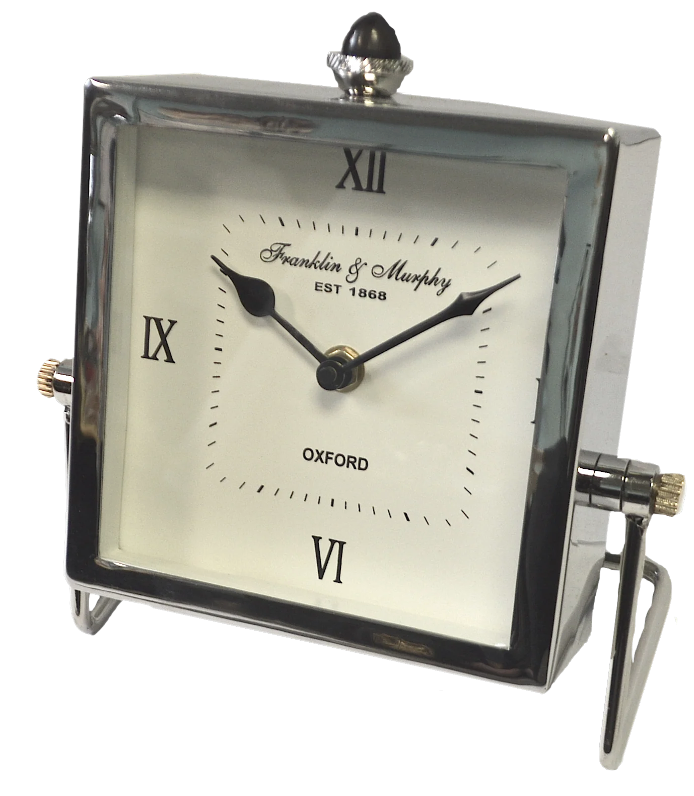 The A Sanoma - Unique Clock II - KG1201 is a handmade square table clock with a nickel finish, Roman numerals, black hands, and stands on two legs. The silver face reads Franklin & Murphy, EST 1868, OXFORD and displays 10:10.