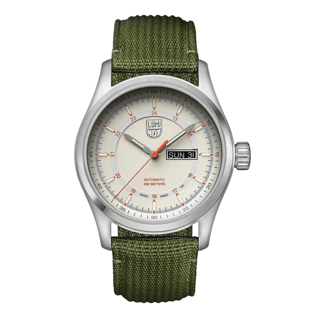 A Luminox watch with a white dial, orange accents, and a green textile strap. The watch has a stainless steel case and a sapphire crystal glass cover.