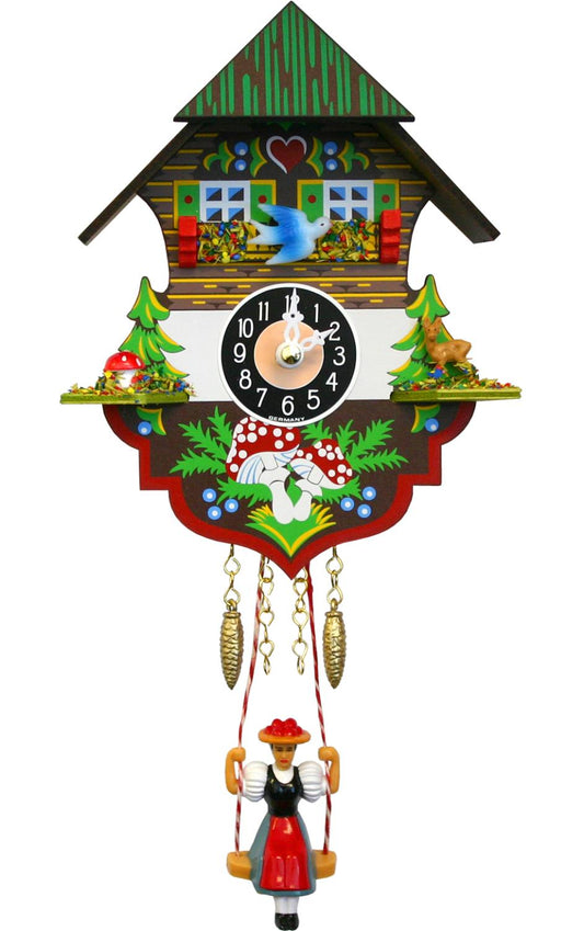 The Alexander Taron, Inc. Chalet Quartz Cuckoo - 0197SQ features a charming house design with pine trees, animals, and a swinging girl in folk dress. This German-made, battery-operated clock has two pinecone-shaped weights and is crafted by Alexander Taron Inc.