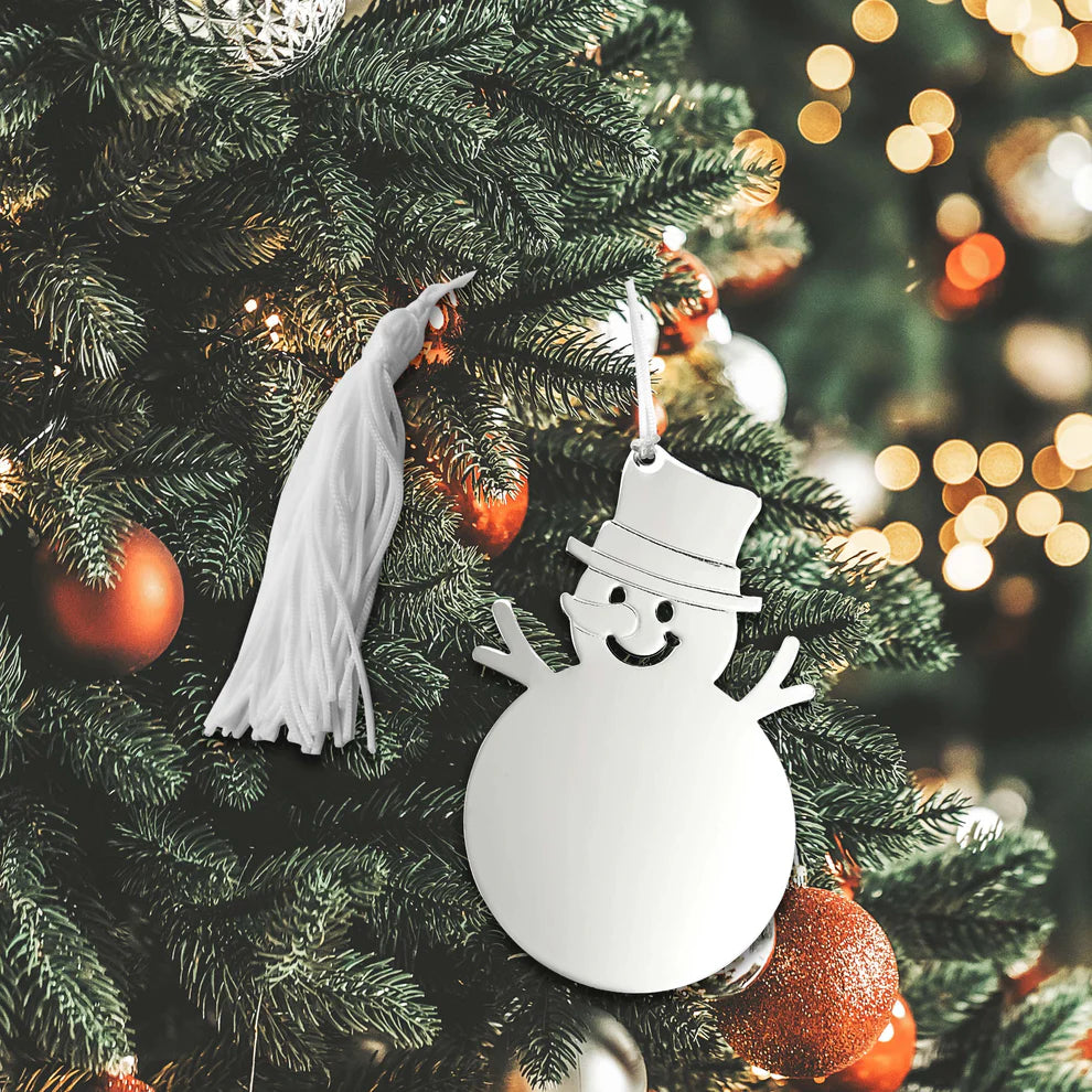 The Creative Gifts - Snowman - 19946 ornament from Creative Gifts features a shiny snowman with a top hat hanging on a festive Christmas tree, surrounded by glowing lights, red and gold baubles, and an elegant engraved ornament.