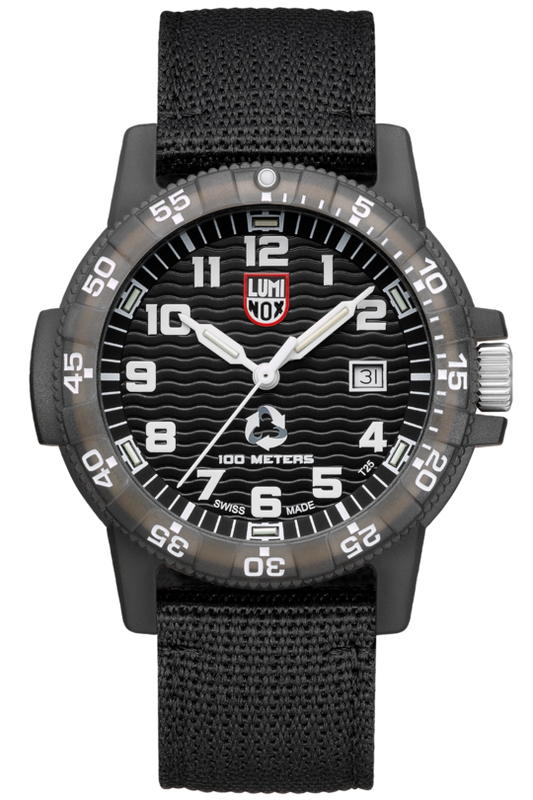 The Luminox TIDE Eco Series Watch (XS.0321.ECO) features a black design, textured strap, bold white numerals, white hands, red and white logo at 12 o’clock, date at 3 o’clock, Swiss-made movement, and is water resistant up to 100 meters.