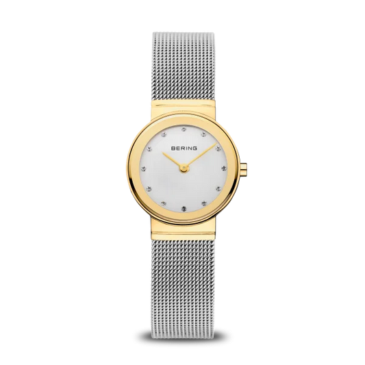 The Bering Watch - Classic Collection Womens Gold (10126-001) features a gold-tone round case, white dial with crystal markers, and a silver mesh band—showcasing Bering’s Danish-inspired design against a plain white background.