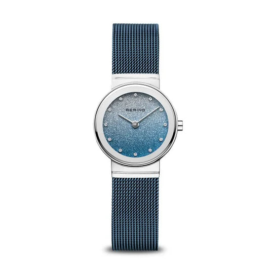 The Bering Watch - Classic Collection - Blue & Silver Stardust Dial (10126-3073) features a blue mesh stainless steel band, silver round case, blue gradient dial with crystal hour markers, and the Bering brand displayed on the face.