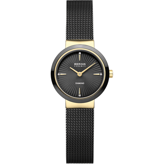 The Bering Watch - Diamond Collection - 10725-132 is a stylish women’s wristwatch from Bering, featuring a black mesh band, gold accents, and a black dial with diamond hour markers at the 12, 3, 6, and 9 o’clock positions.