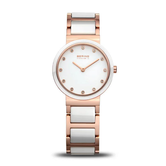 The Bering Watch - Ladies Ceramic with Pendant (10725-766) features a rose gold and white ceramic band, round white face, crystal hour markers, slim design, and gold hands. The BERING logo is displayed at the top.